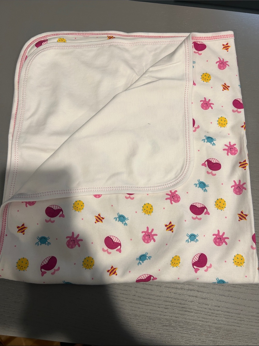 Kissy Kissy White blanket with Pink, Yellow and Blue Sea Creature Print
